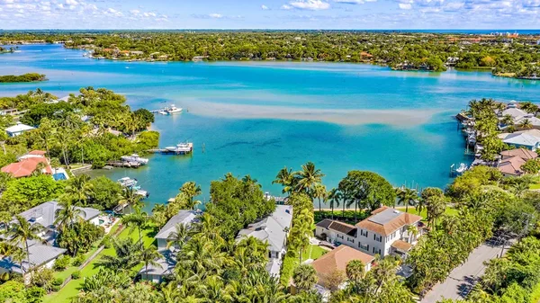 Loxahatchee River waterfront homes and blue water on a sunny day