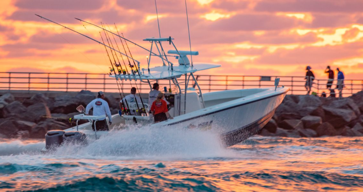 a boat heading out of Jupiter Inlet at sunrise for a day of fishing